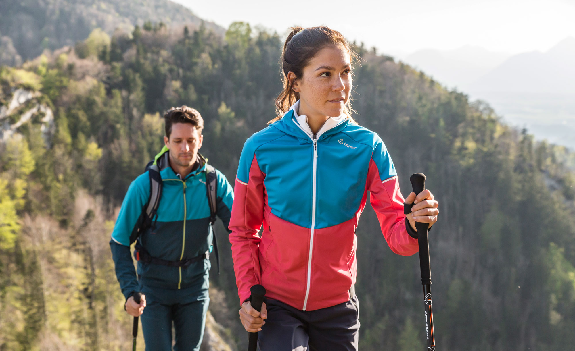 Ein Paar bei einer Wanderung, sie tragen Jacken von der Marke Löffler.